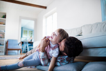 Father and daughter sharing a joyful moment playing together at home