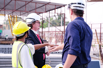 Engineers meet, design, and plan building structures at construction sites.