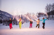 © oneinchpunch - Group of snowboarders on winter holiday season having fun and bonding outdoors in the snow