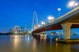 Fototapeta  - Landscape of Ba Son cable-stayed bridge spanning the Saigon River at night in Ho Chi Minh City, Vietnam.