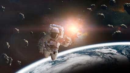 Wall Mural - cosmonaut with asteroids in low-earth orbit. elements of this image furnished by nasa.