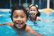 Diverse young children enjoying swimming lessons in pool, learning water safety skills, joyful activity,
