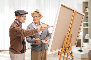 Poster - Cheerful elderly men painting on a canvas