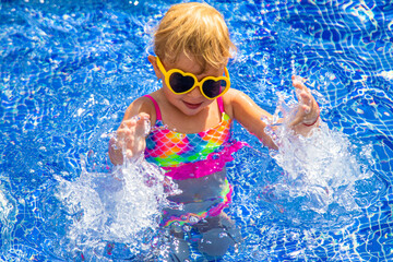 Poster - Child near the pool in sunglasses. Selective focus.