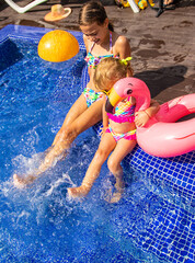 Poster - Child near the pool in sunglasses. Selective focus.