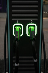 Two charging handles of an electric car charger.