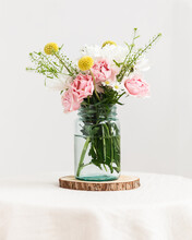 Glass Mason Jar With Fresh Wildflowers Inside On Table