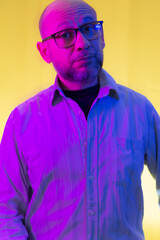 Bald, bearded man wearing prescription glasses