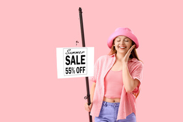 Sticker - Happy young woman with fishing rod and SALE sign on pink background. Concept of discount