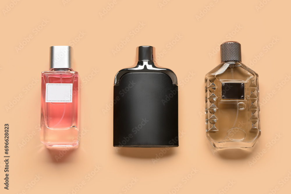 Bottles of luxury perfume on orange background