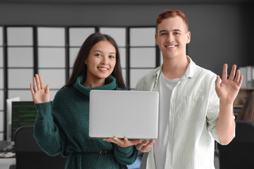 Canvas Print - Young programmers with laptop in office