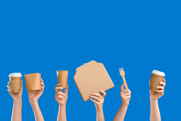 Wall Mural - Female hands with different takeaway containers on blue background