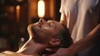 A man is shown receiving a relaxing facial massage at a spa. This image can be used to promote the benefits of spa treatments and self-care practices