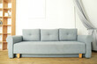 © Atlas - Gray sofa with wooden shelves on the background