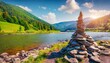 picturesque summer view of stone pyramid is laid out by tourists on the shore of zhenets river splendid outdoor scene of carpathian mountains ukraine europe beauty of nature concept background