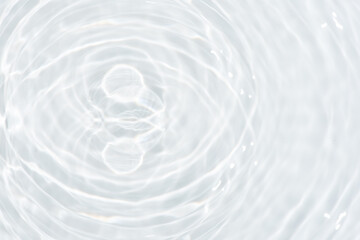 Wall Mural - White water with ripples on the surface. Defocus blurred transparent white colored clear calm water surface texture with splashes and bubbles. Water waves with shining pattern texture background.