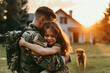 © ronstik - emotional meeting of soldier and daughter in front of the house while coming home from duty. hug each other