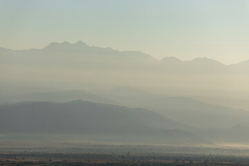 Wall Mural - valley in the mountains at dawn in the fog