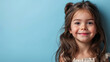 Portrait of little pretty brunette hair girl child in dress with expression of joy on face, cute smiling isolated on a flat pastel blue background with copy space. Template for banner, text place.