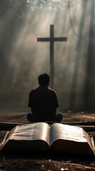 A man sitting by an open Bible is engrossed in prayer