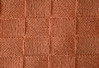 Wall Mural - Unusual abstract knitted chess pattern background texture. Top view, close-up. Handmade knitting wool 