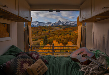 Vanlife Remote Work Nomad Interior Bedding Doors Open Autumn Colorado Dallas Divide. Freedom Acoustic Guitar