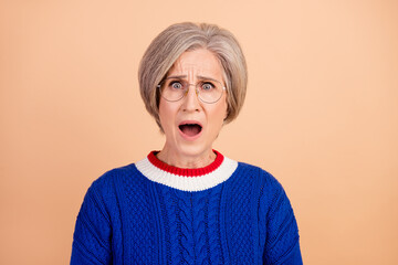 Sticker - Photo of horrified scared woman with gray hair dressed knitwear sweater in glasses staring open mouth isolated on beige color background