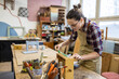 © pikselstock - Female carpenter working in her workshop