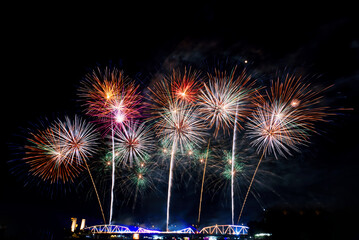 Huge fireworks and pyrotechnics light up the night sky. A festival of celebration and a message of happiness. Blurry or blurry