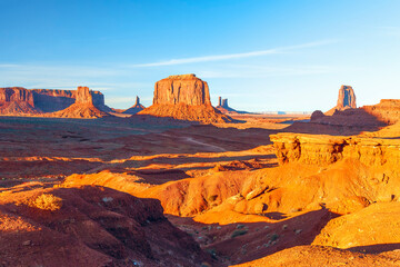 Wall Mural - View of the red sandstone formations of Monument Valley at sunset