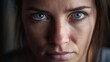 Intense Gaze: A Woman with Piercing Blue Eyes Conveys Depth and Emotion