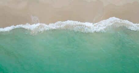 Wall Mural - Nature video Empty beach. Beach sea top-view water wave foamy come in sandy beach Phuket Thailand