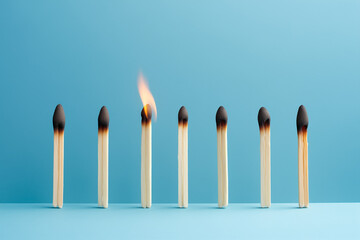 Burning matches on a light blue background. Minimal concept. Copy space.