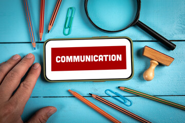 Wall Mural - communication concept. mobile phone on wooden office table