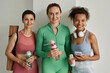 © Seventyfour - Diverse group of women wearing workout clothes and smiling at camera in gym