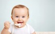 little cute caucasian toddler baby trying and enjoying the baby food or porridge himself with a spoon; Self nutrition concept