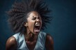 an angry african american young woman yelling at the camera. angry and distressed looking. hair is messy. 