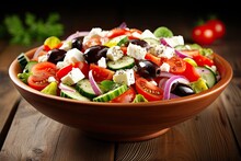 Greek Salad With Feta, Tomatoes, Cucumber, Red Pepper, Olives, And Onion On A Table.