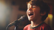 A young boy is singing into a microphone 