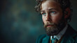 © Delta Amphule - A feminine man with a beard looking at the camera. WEaring a suit with piercing blue eyes. Vintage refined suave style dress. Shallow depth of field.