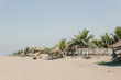 sunny beach in mexico with palm trees and huts