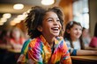  A joyous young girl with fluffy curls and a colorful jacket laughs in a sunlit school cafeteria, her happiness infectious.