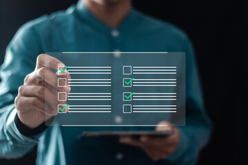 Wall Mural - Businessman filling survey form online on questionnaire with checkboxes for answer questions of test.