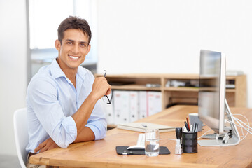 Web design, portrait or happy man with computer for IT support with technology for project or solution. Smile, business or proud employee programming with glasses or research online at desk in office