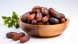 dried dates in a wooden bowl isolated in white background