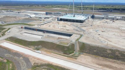 Wall Mural - Aerial drone pullback reverse view of the construction site of the new Western Sydney International Airport at Badgerys Creek in Western Sydney, NSW on a sunny day shot on 23 December 2023