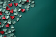 Felicitación de San Valentín: Recortes de corazones de papel de colores sobre fondo verde liso.