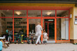 © Maskot - Senior woman with granddaughter standing near door of kindergarten