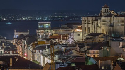 Wall Mural - Lisbon from above night timelapse: view of illuminated Baixa district with Santa Justa Lift, also called Carmo Lift and Convento da Ordem do Carmo, historical church. View from above. Portugal