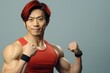 © Fotograf - A man wearing a red tank top poses for a picture. This image can be used for various purposes